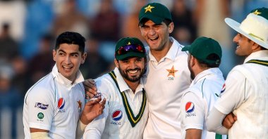 Pakistan's Naseem Shah (2nd L) celebrates with teammates Azhar Ali (L) and Shaheen Shah Afridi (C) after the dismissal of Bangladesh's Mohammad Mithun (unseen) during the first day of the first cricket Test match between Pakistan and Bangladesh at the Rawalpindi Cricket Stadium in Rawalpindi, Pakistan, Feb. 7, 2020.