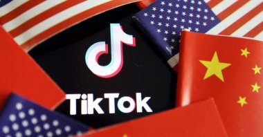 This illustration shows the Chinese and U.S. flags near a TikTok logo. (Reuters Photo)