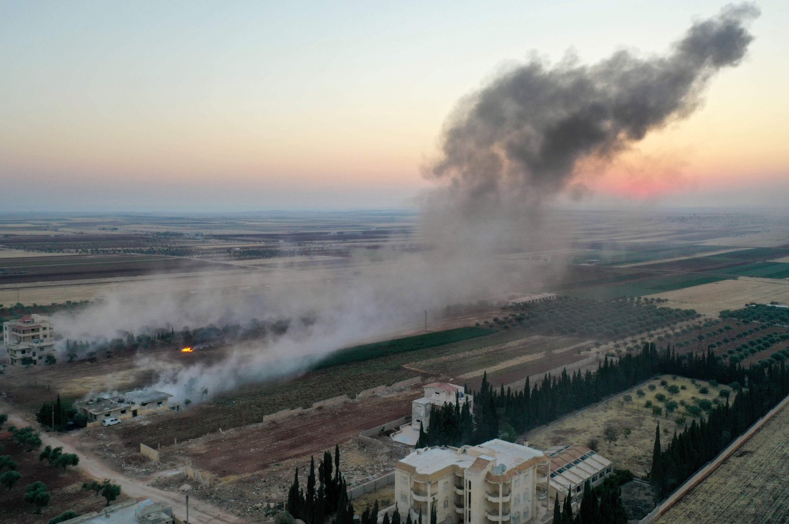 Smoke billows following airstrikes and shellings on the town of Binnish in opposition-controlled Idlib province, northwestern Syria, Aug. 3, 2020. (AFP Photo)
