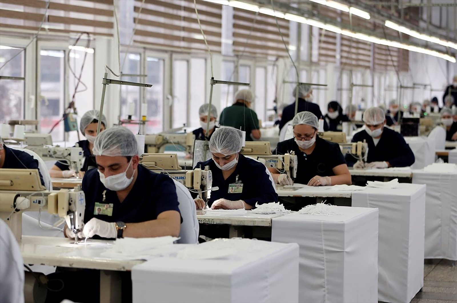 Textile workers produce protective face masks at a textile atelier in Ankara, Turkey, March 26, 2020. (AA Photo)