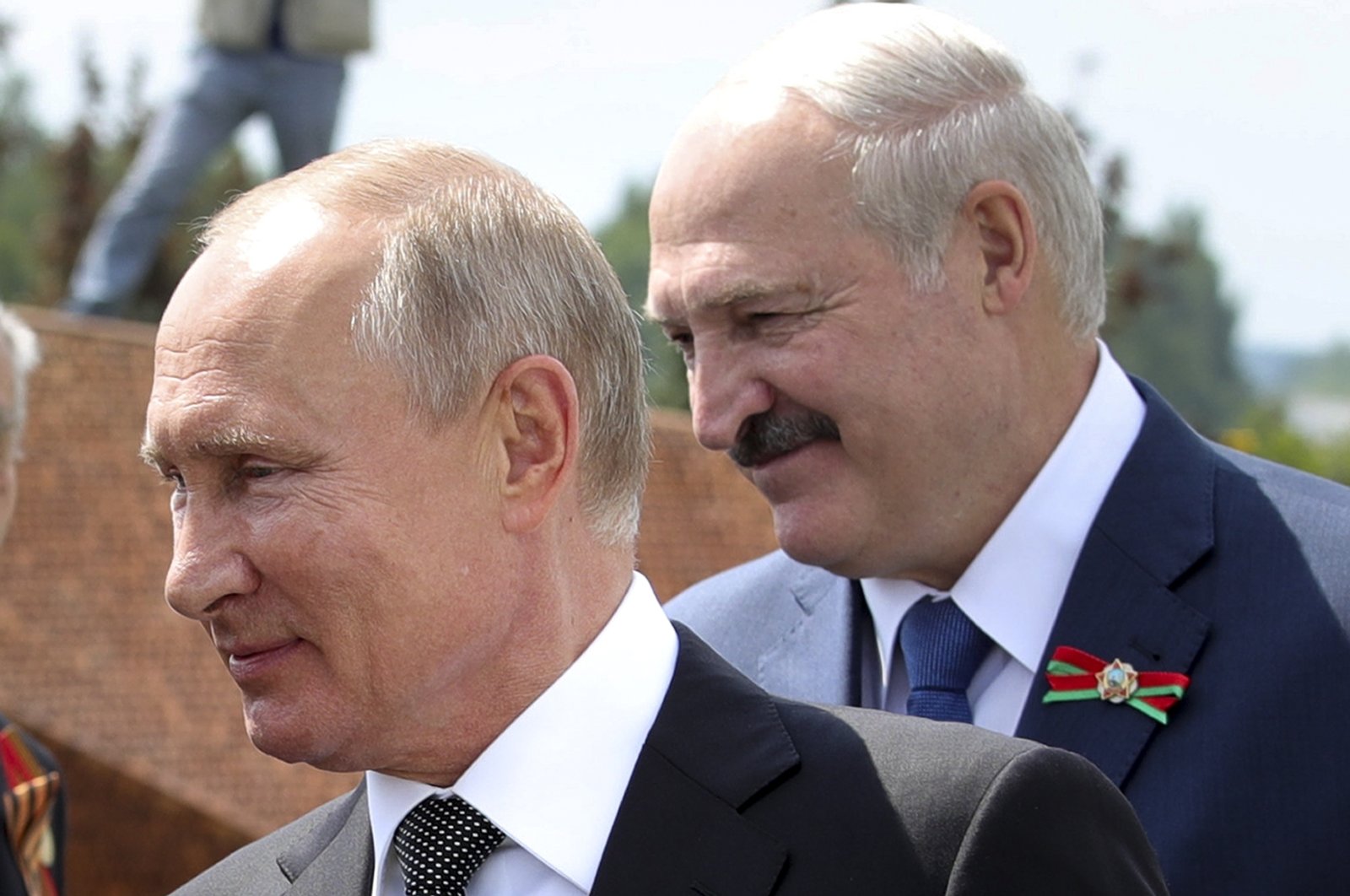 In this June 30, 2020 file photo, Russian President Vladimir Putin (L) and Belarusian President Alexander Lukashenko greet World War II veterans during an opening ceremony of the monument in honor of the World War II Red Army, in the village of Khoroshevo, Russia. (AP Photo)