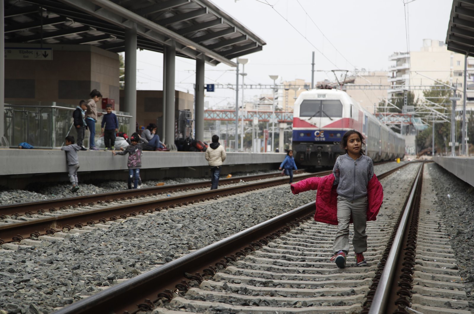 A migrant boy walks on a rail track at the Larissis Station in Athens, Greece, April 5, 2019. (AP Photo)