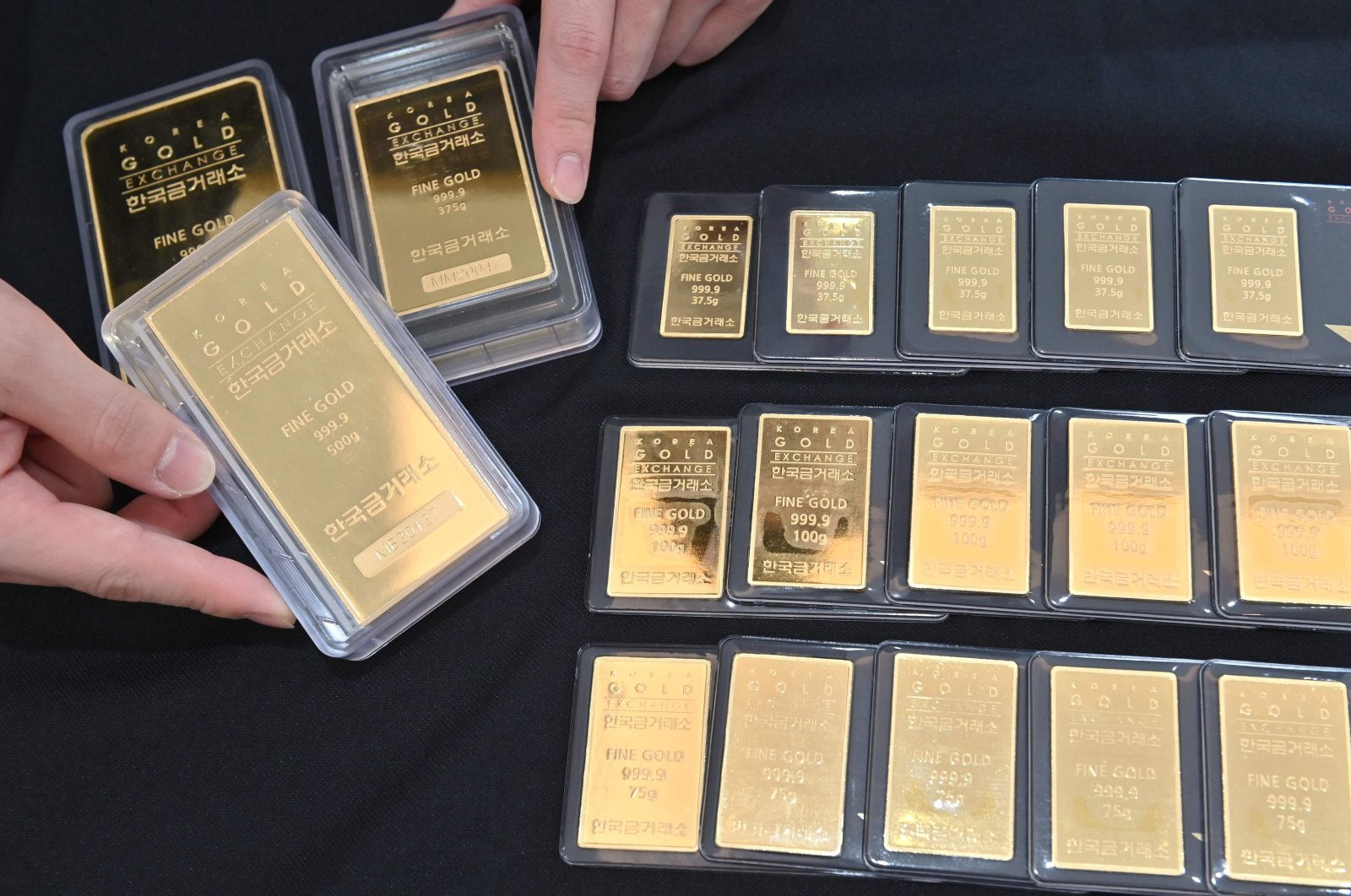 An employee displays gold bars at a Korea Gold Exchange shop in Seoul, South Korea on July 30, 2020. (AFP Photo)
