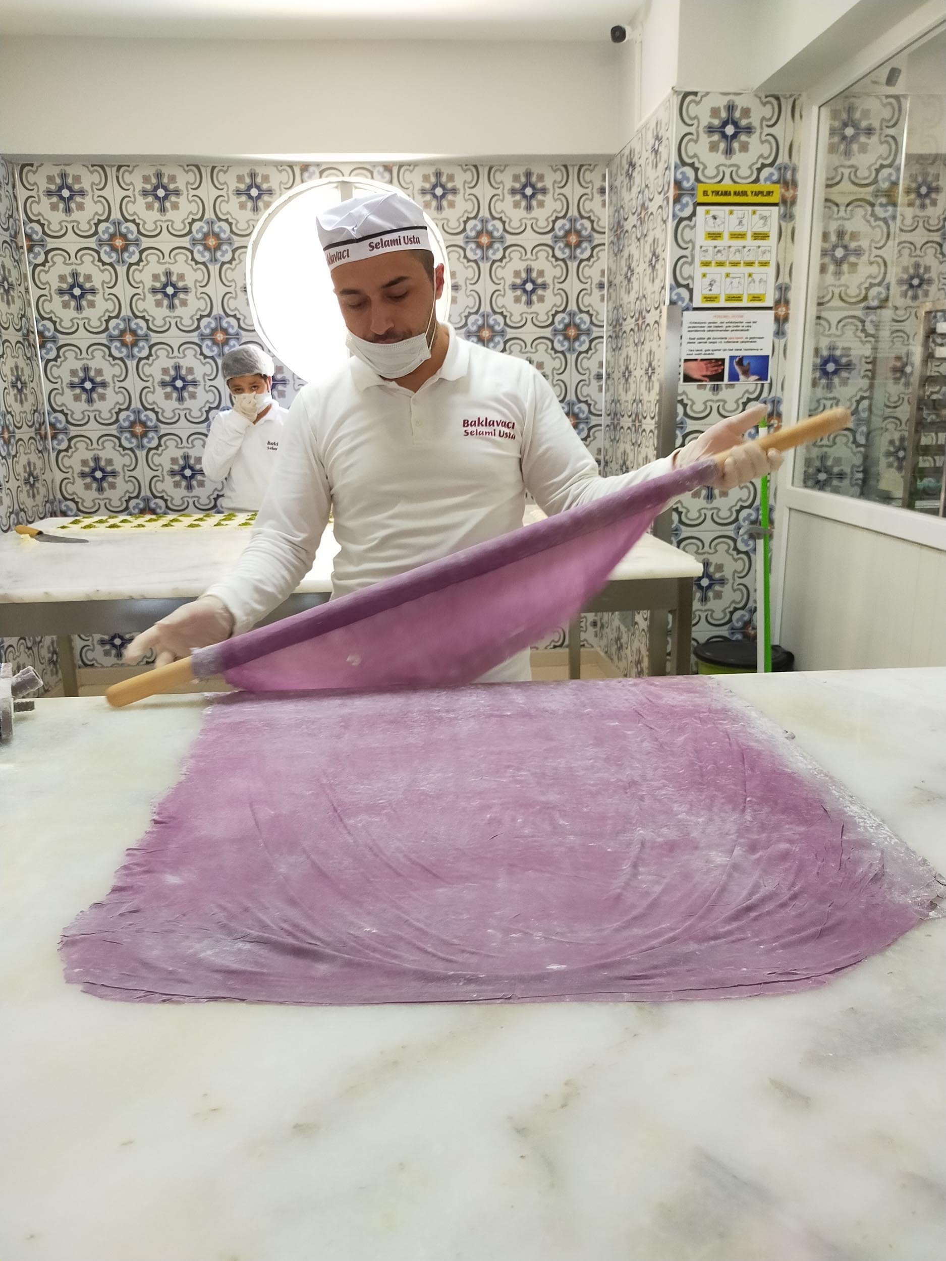 Baker Selami Atiş rolls out purple dough for his diabetes-friendly baklava in Erzurum, Turkey, Aug 3, 2020. (DHA Photo)