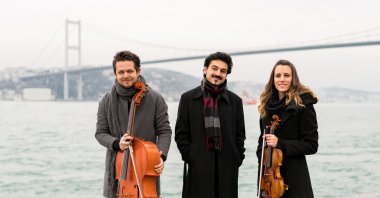 Çağlayan Çetin (L), Özgür Ünaldı (M) and Özgecan Günöz (R) pose in front of the Bosporus Bridge, Istanbul in this photo provided on Aug. 4, 2020.