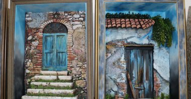 Two works depicting old Mersin houses that were made with a relief technique, Aug. 4, 2020. (AA PHOTO)