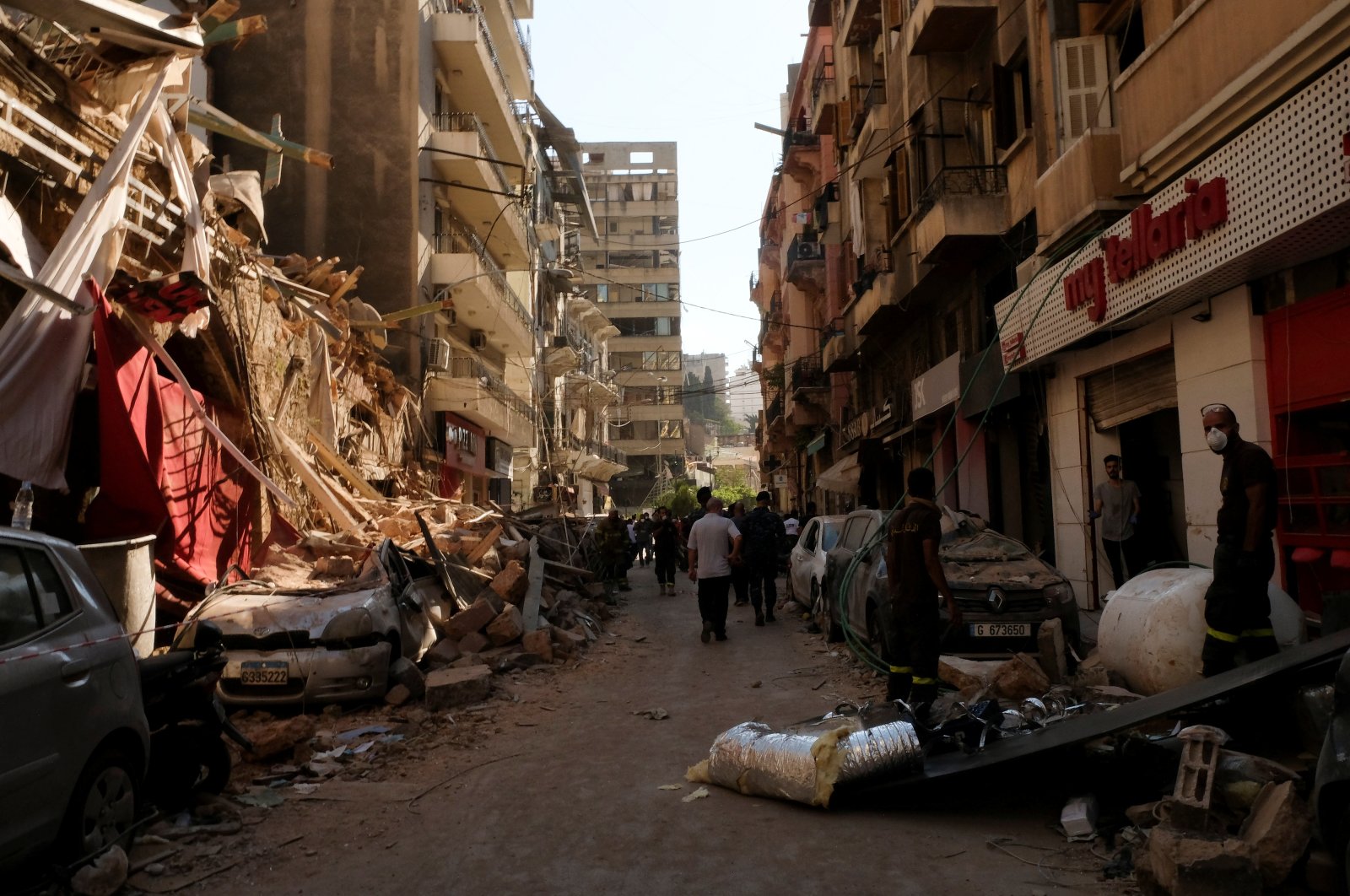 People walk past damaged buildings and vehicles following the blast in Beirut's port area, Aug. 5, 2020. (REUTERS Photo)