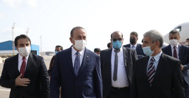 Foreign Minister Mevlüt Çavuşoğlu (C) and Malta's Foreign Minister Evarist Bartolo (R) walk on the tarmac after landing in Tripoli, Libya, Aug. 6, 2020. (AA)