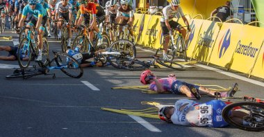Cyclists lie on the street following a crash in the sprint during the Tour of Poland cycling race, between Chorzow and Katowice, Poland, Aug. 5, 2020. (EPA Photo)