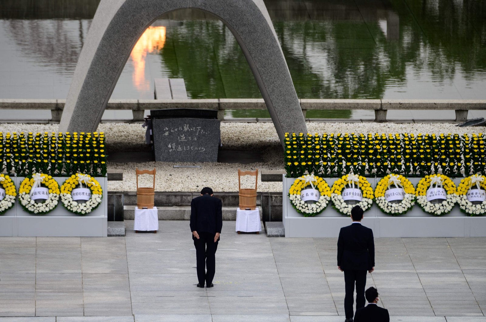 Japanese Prime Minister Shinzo Abe (C) bows in front of the Memorial Cenotaph after delivering a speech during the 75th anniversary memorial service for atomic bomb victims at the Peace Memorial Park in Hiroshima on Aug. 6, 2020. (AFP Photo)