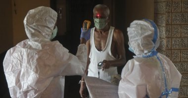 Health workers screen people for COVID-19 symptoms at a residential building in Dharavi, one of Asia's biggest slums, in Mumbai, India, Aug. 7, 2020. (AP Photo)