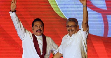 Former Sri Lankan President Mahinda Rajapaksa (L) and former Defense Secretary and his brother Gotabaya Rajapaksa wave at supporters during a party convention held to announce the presidential candidacy, Colombo, Aug. 11, 2019. (AP Photo)