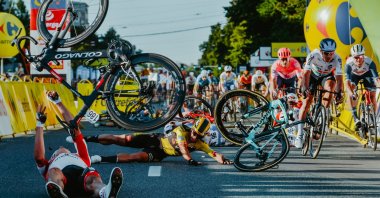 Dutch cyclist Dylan Groenewegen, in yellow jersey, and fellow riders collide during the opening stage of the Tour of Poland race in Katowice, Poland, Aug. 5, 2020. (AFP Photo)