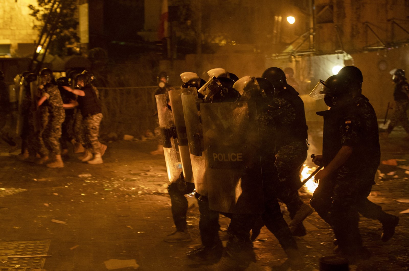 Riot police advance to push back anti-government protesters, Beirut, Aug. 7, 2020. (AP Photo)
