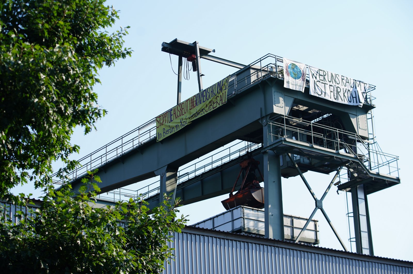 A banner reading "who evicts us is for coal" hangs at the thermal power station Moabit in Berlin, Germany, Aug. 8, 2020. (EPA Photo)