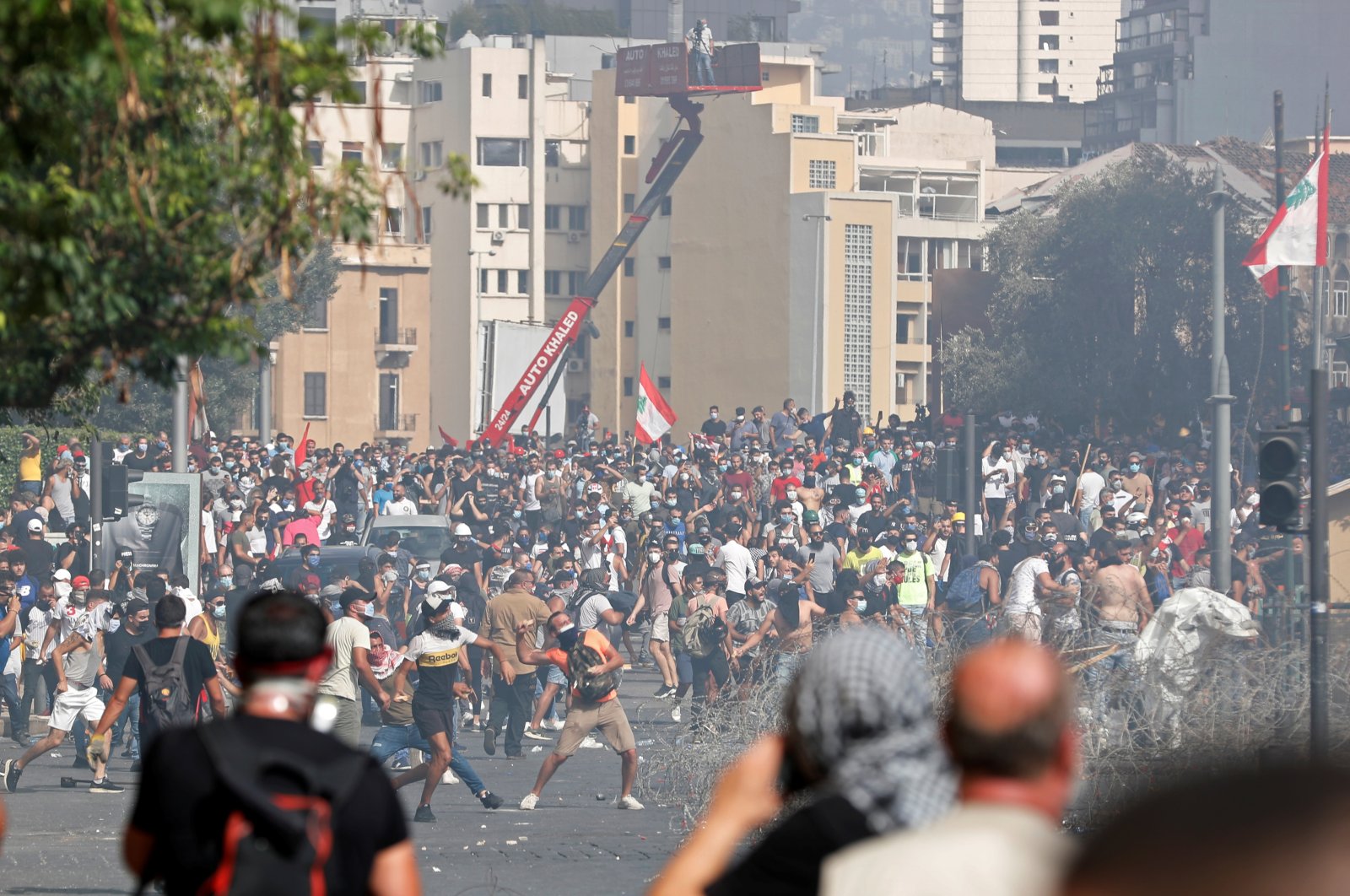 Demonstrators throw stones during a protest as they try to break through a barrier to get to the parliament building following Tuesday's blast, in Beirut, Lebanon August 8, 2020. (REUTERS Photo)