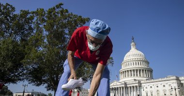 Scott Weinstein, a nurse at Washington Hospital places nurses shoes during a Vigil For Nurses Who've Died From Covid-19 at the U.S. Capital on July 21, 2020 in Washington, DC. (AFP Photo)