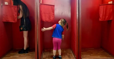 A girl looks into a voting booth at a polling station during the presidential election in Minsk, Belarus, Aug. 9, 2020. (AFP Photo)