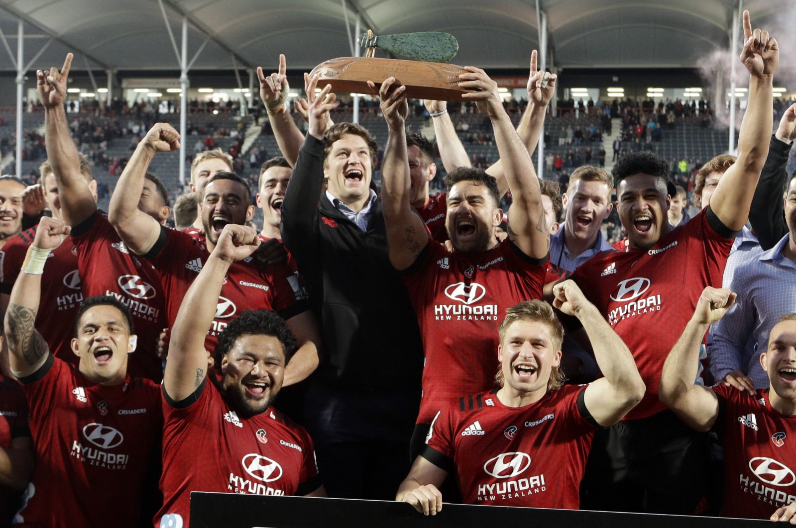 Crusaders Codie Taylor and injured teammate Scott Barrett hold the Super Rugby Aotearoa trophy aloft after defeating the Highlanders in Christchurch, New Zealand, Aug. 9, 2020. (AP Photo)