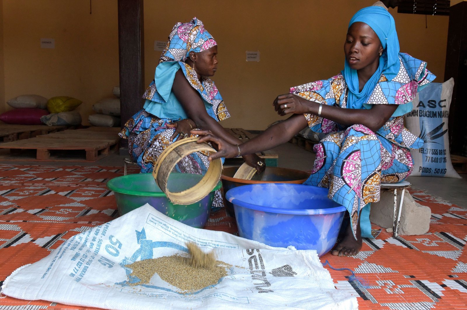 Two women sift millet in Niakhar, Senegal, Dec. 5, 2017. (AFP Photo)