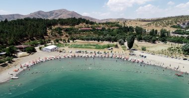 Vacationers on sunbeds are seen at Lake Hazar in Elazığ province, eastern Turkey, Aug. 7, 2020. (AA Photo)