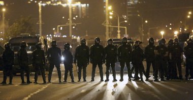 Police block the road to protect against demonstrators after the Belarusian presidential election, Minsk, Belarus, Aug. 9, 2020. (AP Photo)
