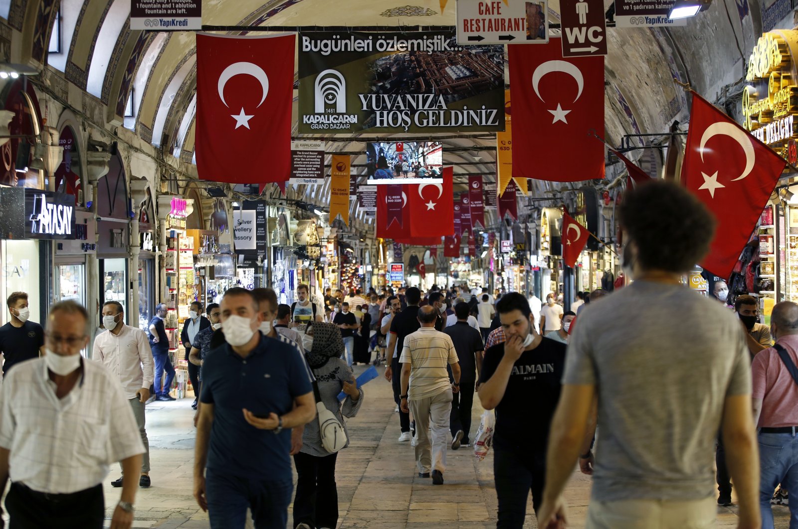 People walk inside historical Grand Bazar in Istanbul, Friday, Aug. 7, 2020. (AP Photo)