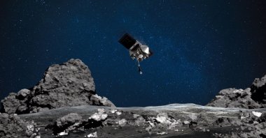 This NASA image shows an artist's rendering of the OSIRIS-REx spacecraft descending toward asteroid Bennu to collect a sample of the asteroid’s surface, Aug. 11, 2020. (AFP Photo)