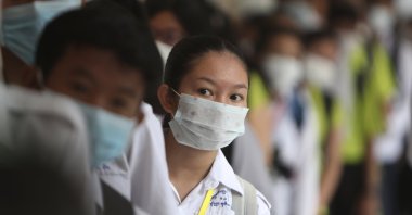 Students line up to sanitize their hands to avoid contact with the coronavirus before their morning class at a high school in Phnom Penh, Cambodia, Jan. 28, 2020. (AP Photo)