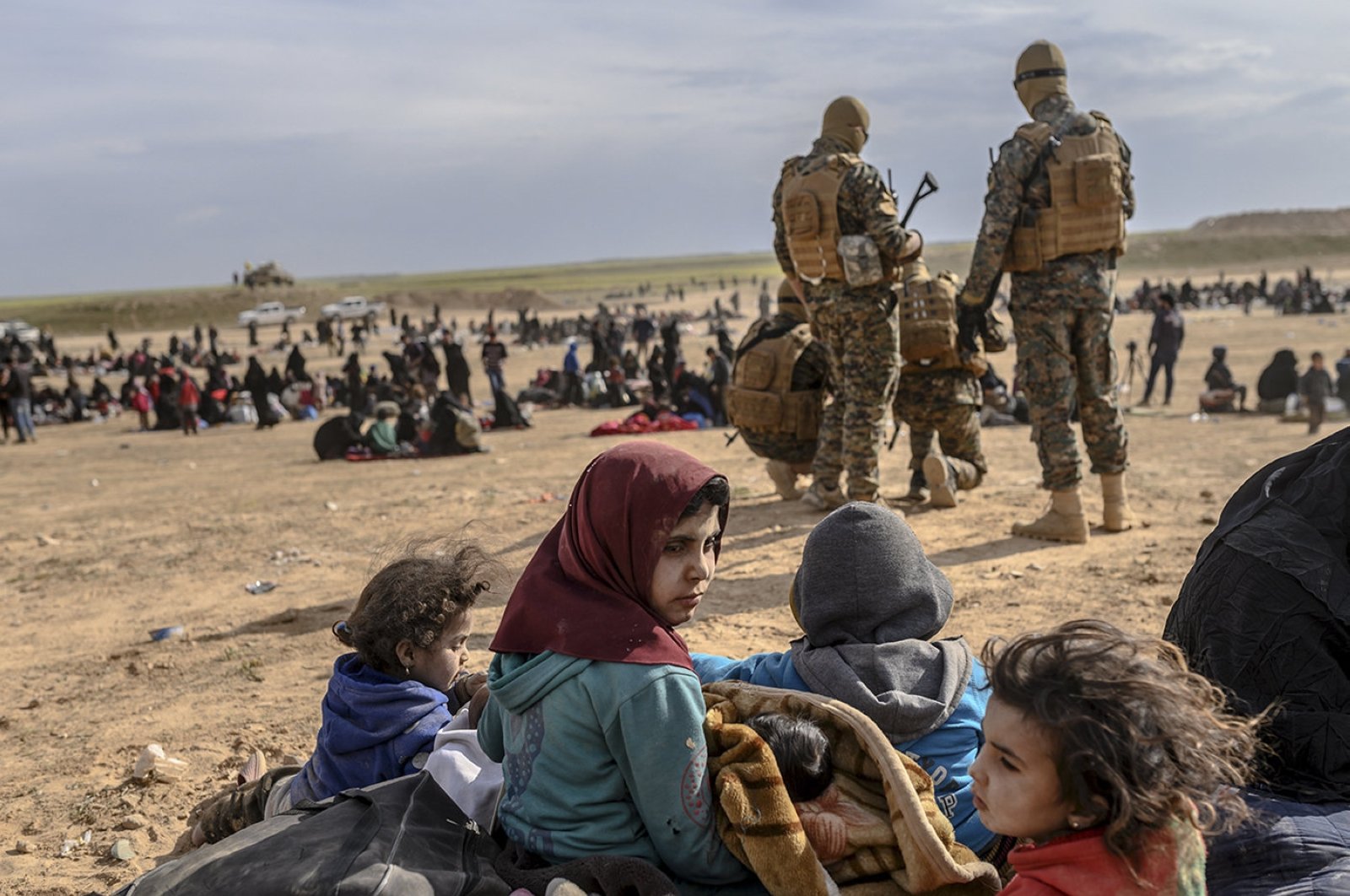 Civilians evacuated from the Daesh group's embattled holdout of Baghouz wait at a screening area held by U.S.-backed YPG/PKK terrorists, in the northeastern Syrian province of Deir el-Zour, March 5, 2019. (AFP File Photo)