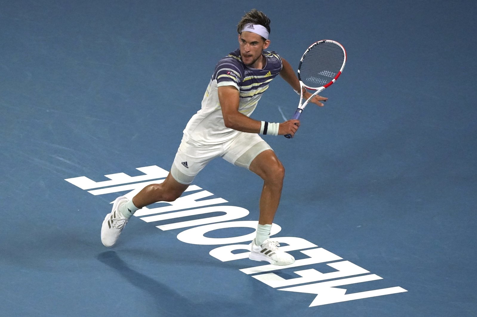 Dominic Thiem runs to play a shot to Rafael Nadal during a quarterfinal match at the Australian Open tennis championship in Melbourne, Australia, Jan. 29, 2020. (AP Photo)