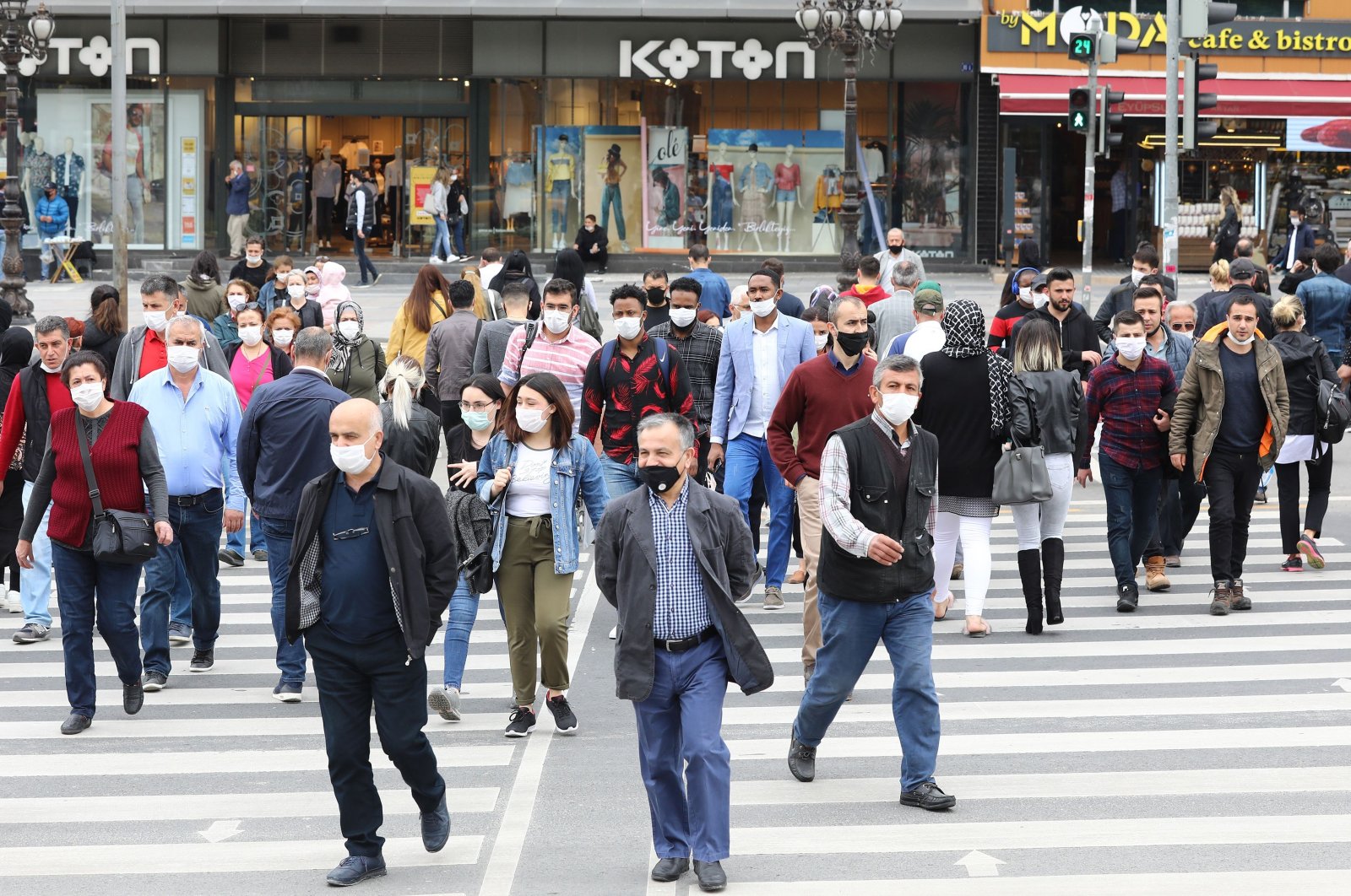 People wearing protective face masks walk on a street in the capital Ankara, Turkey, June 1, 2020. (AFP Photo)
