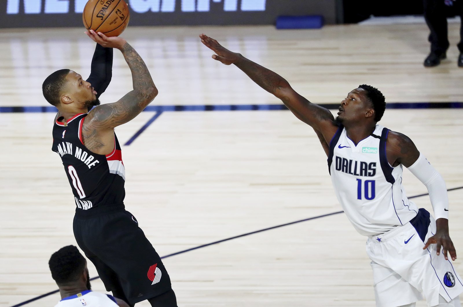 Portland Trail Blazers guard Damian Lillard shoots as Dallas Mavericks forward Dorian Finney-Smith attempts to block during the second half of an NBA basketball game, Lake Buena Vista, Florida, U.S., Aug. 11, 2020. (AP Photo)