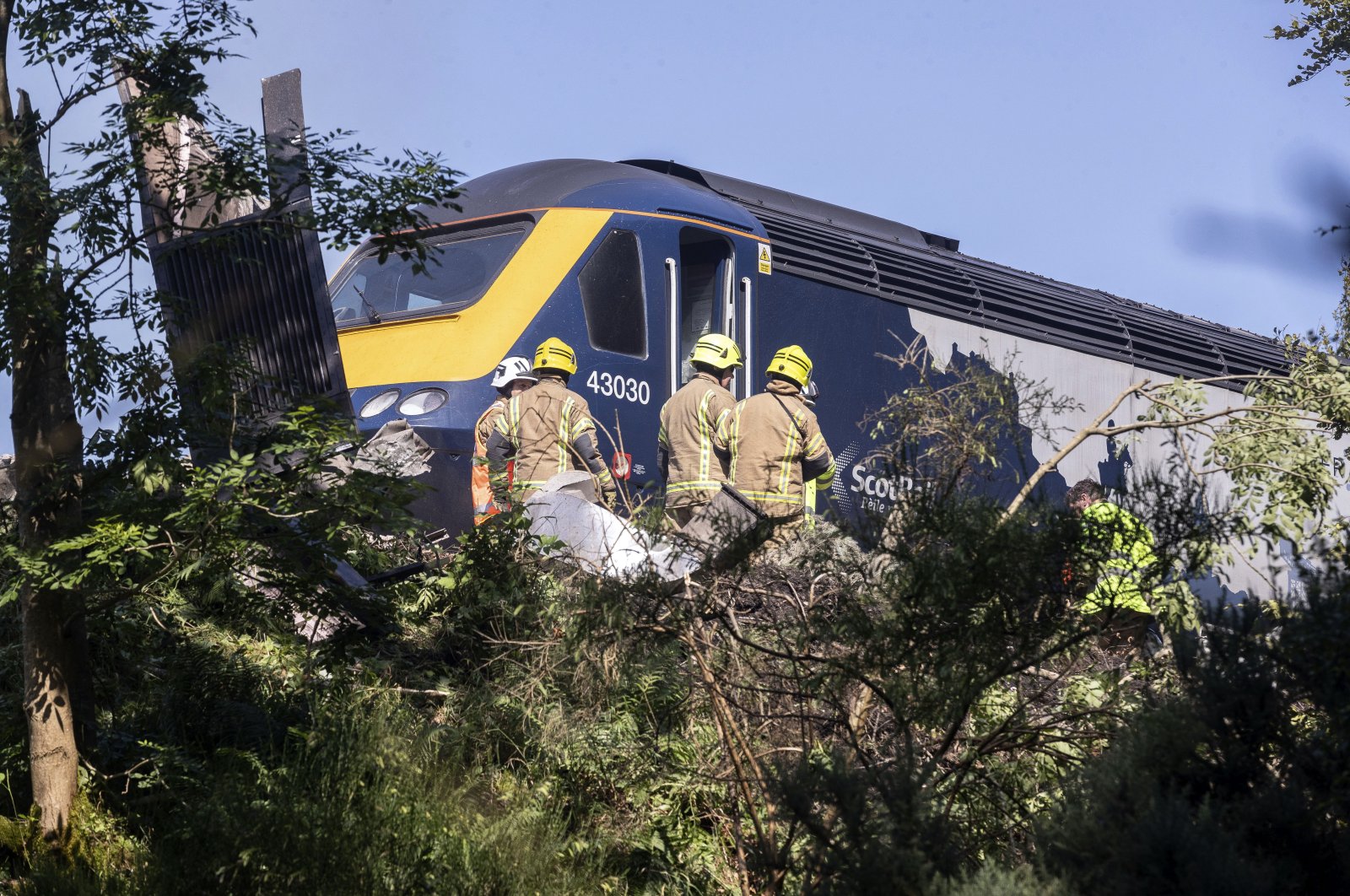 Emergency services attend the scene of a derailed train in Stonehaven, Scotland, Aug. 12, 2020. (AP Photo)