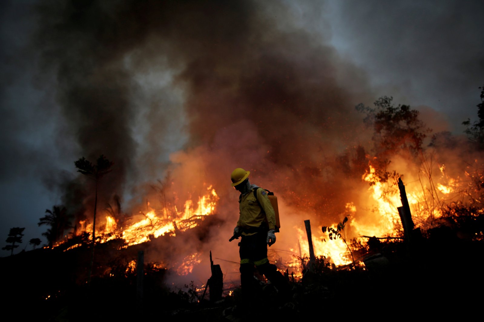 A Brazilian Institute for the Environment and Renewable Natural Resources (IBAMA) fire brigade member attempts to control a fire in a tract of the Amazon jungle in Apui, Amazonas State, Brazil, Aug. 11, 2020. (Reuters Photo)