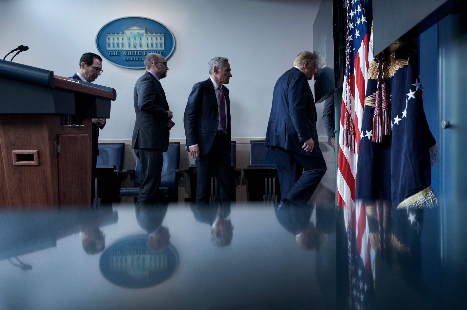 U.S. Secretary of the Treasury Steven Mnuchin, Director of the Office of Management and Budget Russell Vought, member of the coronavirus task force Scott Atlas, and U.S. President Donald Trump leave after a briefing at the White House, Aug. 10, 2020, in Washington, D.C. (AFP Photo)