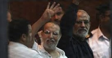 Muslim Brotherhood's Supreme Guide Mohamed Badie (R) and Muslim Brotherhood leader Essam El-Erian (C) gesture during their trial at a court in Cairo, Egypt, Aug. 30, 2014. (Reuters Photo)