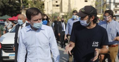 U.S. Undersecretary of State for Political Affairs David Hale, left, speaks with an NGO volunteer during his visit to the main gathering point for volunteers, near the site of last week's explosion that hit the seaport of Beirut, Lebanon, Aug. 13, 2020. (AP Photo)