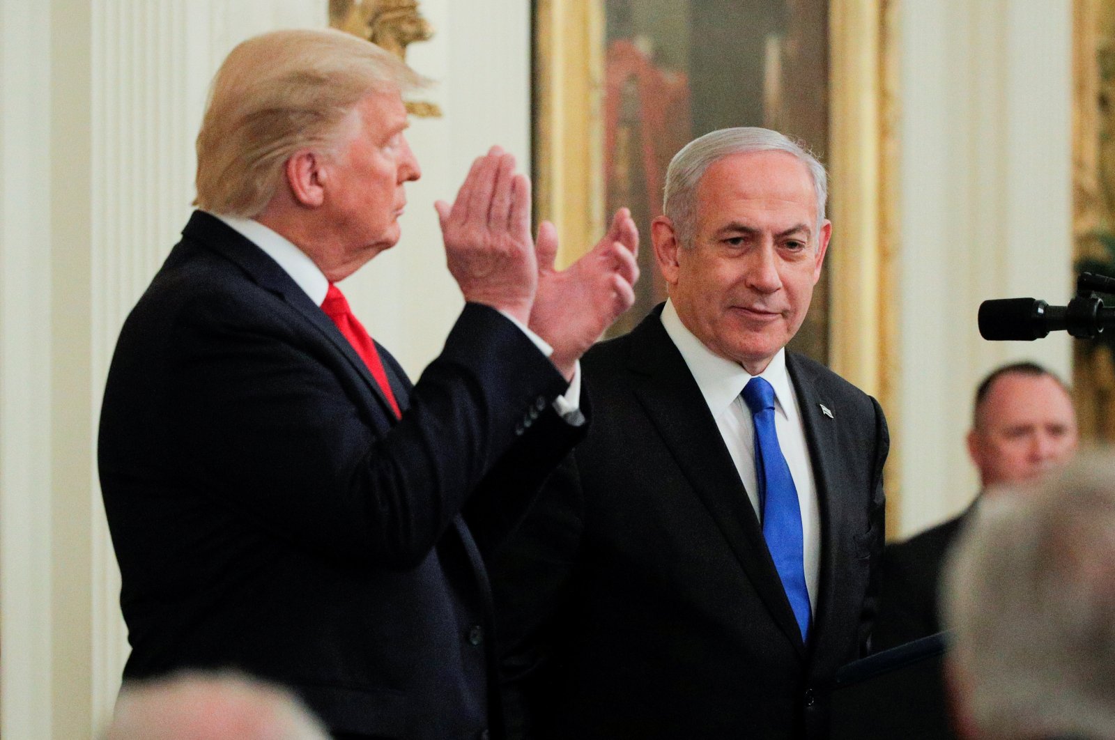U.S. President Donald Trump applauds Israel's Prime Minister Benjamin Netanyahu as they appear together at a joint news conference to discuss a new Middle East peace plan proposal in the East Room of the White House in Washington, Jan. 28, 2020. (REUTERS Photo)