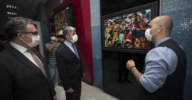 Metin Mutanoğlu (L) and Amb. Muhammad Syrus Sajjad Qazi (M) visit the "Colors of Pakistan Through the Eyes of Turks" exhibition accompanied by a guide, Ankara, Turkey, Aug. 14, 2020. (AA Photo)