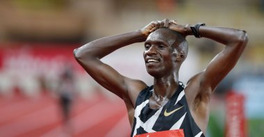 Uganda's Joshua Cheptegei celebrates after winning and breaking the world record in the men's 5000metre event during the Diamond League Athletics Meeting at The Louis II Stadium in Monaco on August 14, 2020. (AFP Photo)