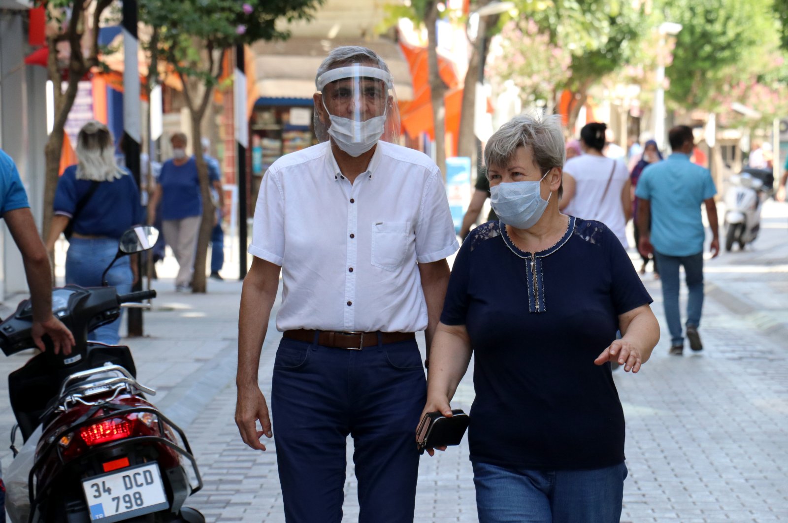 A man and a woman wearing protective masks walk on a street in Kırklareli, northwestern Turkey, Aug. 14, 2020. (AA Photo)