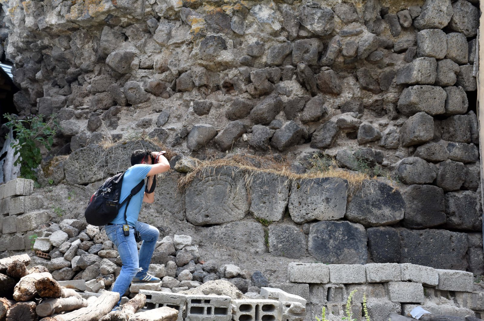 A researcher takes a photo of Malazgirt Citadel, in Muş, eastern Turkey, Aug. 14, 2020. (AA Photo)