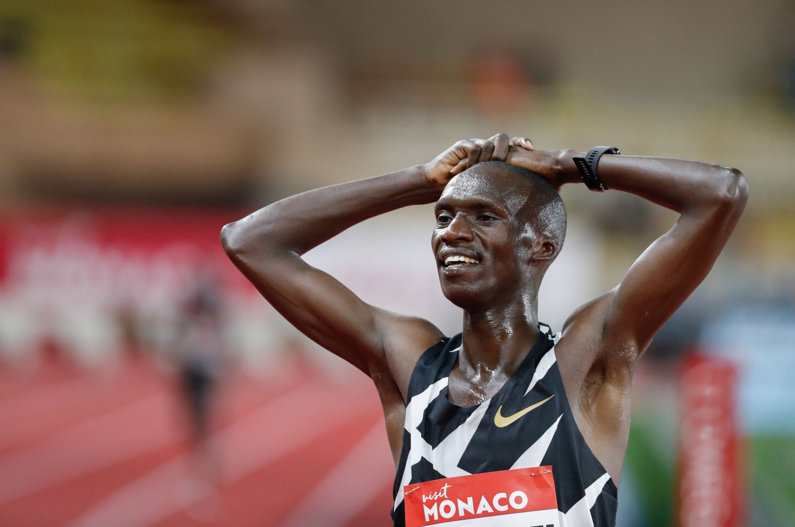 Uganda's Joshua Cheptegei celebrates after winning and breaking the world record in the men's 5000metre event during the Diamond League Athletics Meeting at The Louis II Stadium in Monaco on August 14, 2020. (AFP Photo)