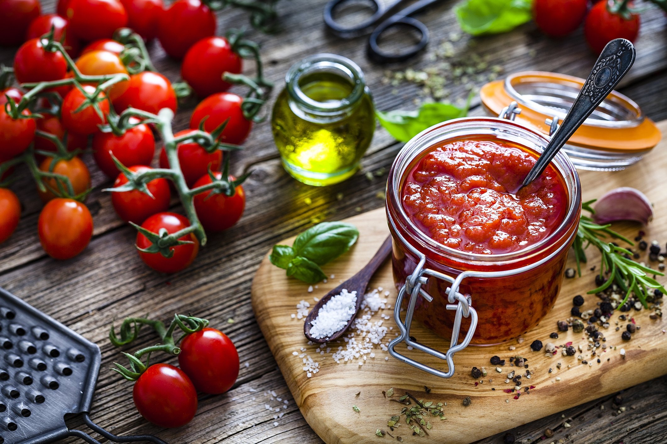 Some people like to add peppers, rosemary, basil and olive oil to their preserved tomatoes with extra flavor. (iStock Photo)