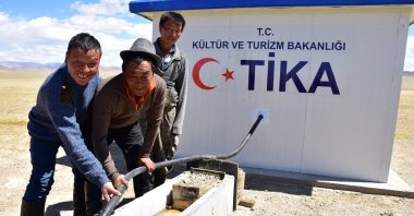 Locals stand by a water well built by TİKA in Bayankhongor, Mongolia, June 17, 2020. (AA Photo)