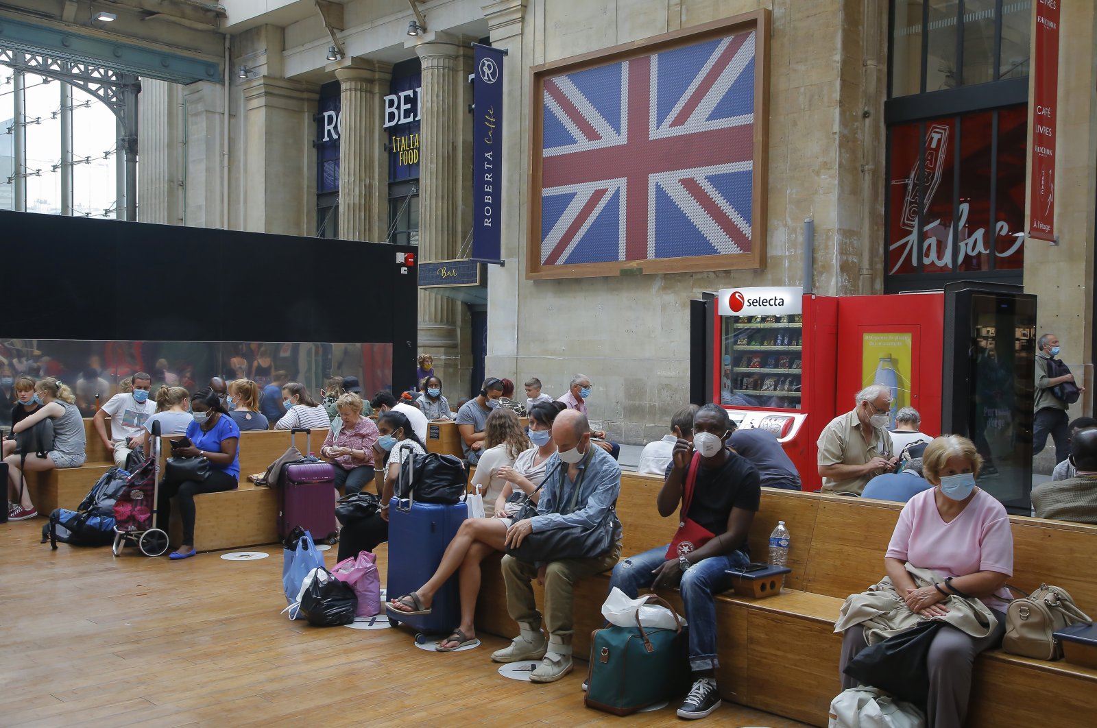 Passengers wait next to the Eurostar Terminal at the Gare du Nord train station, Paris, Aug. 14, 2020. (AP Photo)