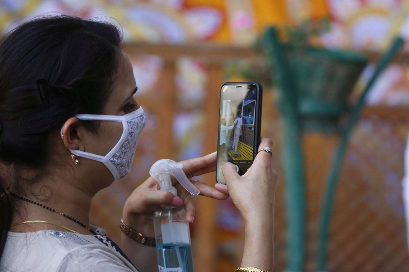 A woman takes a photograph with a cell phone as a paramedic conducts a rapid antigen test in Srinagar, the summer capital of Indian Kashmir, Aug. 10, 2020. (EPA Photo)