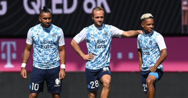 Marseille's Dimitri Payet (L), Valere Germain (C) and Florian Chabrolle (R) stand on the pitch before a match, in Munich, Germany, July 31, 2020. (AFP Photo)