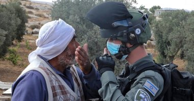 Protestors confront Israeli forces as a structure serving as a home to a Palestinian family is demolished in the village of Susya south Yatta in the southern West Bank, Aug. 11, 2020. (AFP Photo)